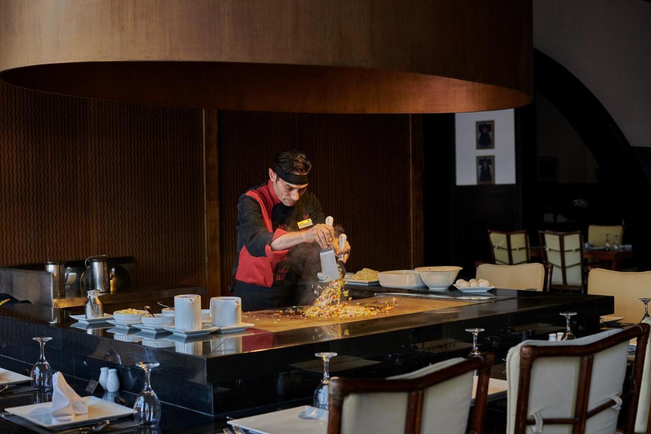 Mosaique Beach Resort Taba Heights Exterior photo A chef at work